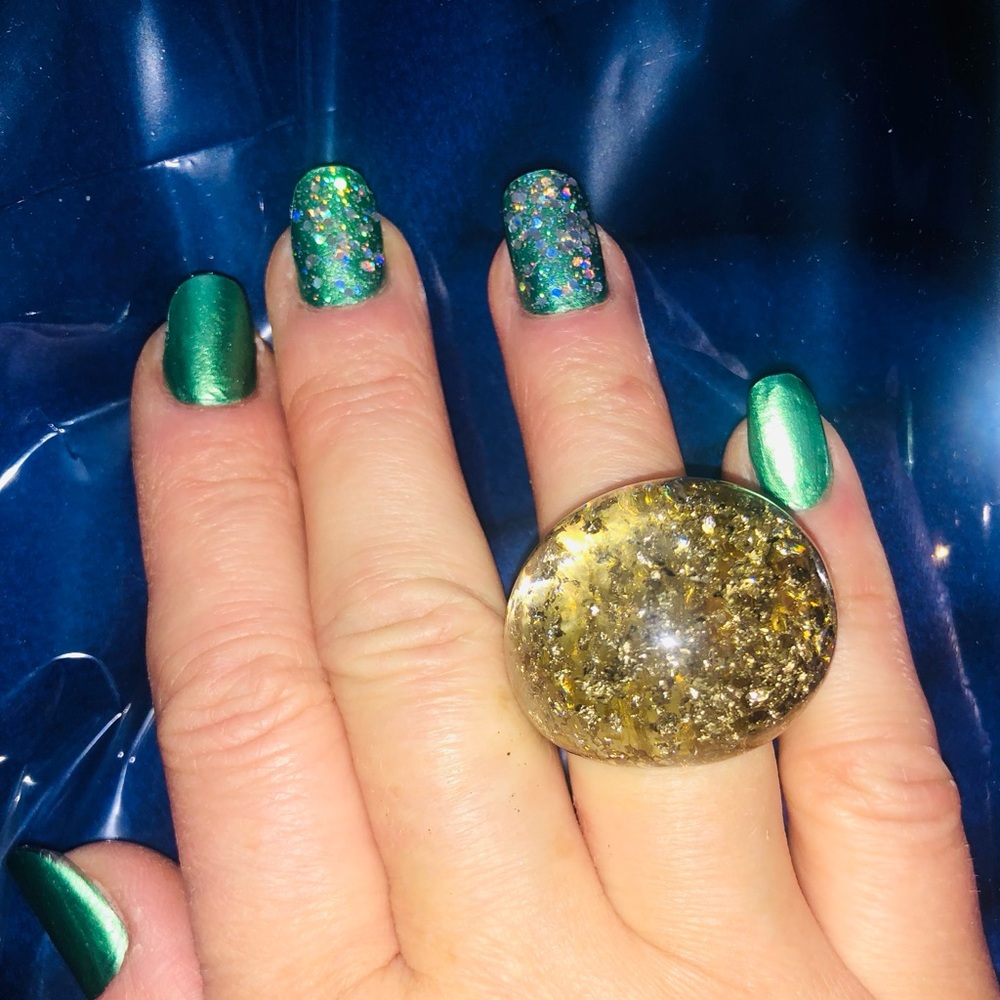 Fashion ring. Gold pieces inside plastic  beautiful ring. Size about 6,5